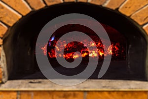 The fire burns in a wood pizza oven