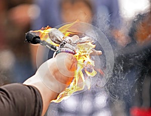 Fire busker juggle arm closeup