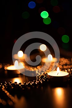 Fire of candle on christmas background. Christmas candles burning at night. Abstract candles background.