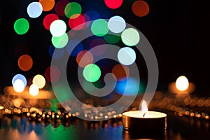 Fire of candle on christmas background. Christmas candles burning at night. Abstract candles background. 