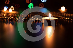 Fire of candle on christmas background. Christmas candles burning at night. Abstract candles background.