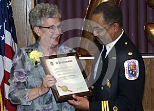 The Prince George`s County Fire Chief give a award to the a member of lfire department`s ladies auxilary adi