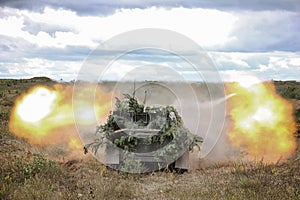 Fire is conducted from an artillery gun photo