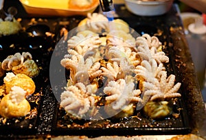 Fire cooking Burning for `Baby Octopus` in Takoyaki Japanese balls.