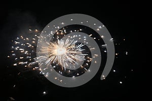 Fire cracker revolving and scattering sparkles on ground at night Diwali festival click Ground Cracker