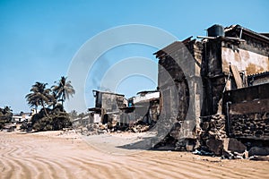 Fire damaged buildings in the middle of popular touristic beach in Sri Lanka. Polluted and damaged place near surfing beach