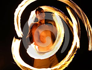 Fire dancer at night in a camp