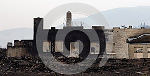 Fire Debris of Houses in a small town with smoke in sky.