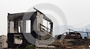 Fire Debris of Houses in a small town with smoke in sky.