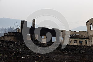 Fire Debris of Houses in a small town with smoke in sky.