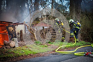 The fire department extinguishes a garden house