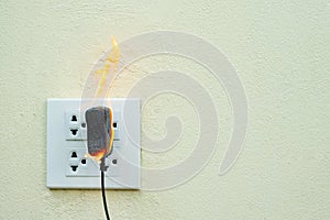 On fire electric wire plug Receptacle and adapter on white background