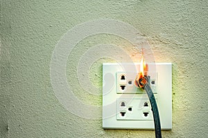 On fire electric wire plug Receptacle and adapter on white background