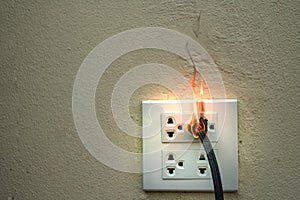 On fire electric wire plug Receptacle and adapter on white background