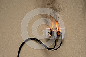 fire electric wire plug Receptacle on the concrete wall background