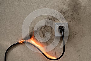 fire electric wire plug Receptacle on the concrete wall exposed concrete background with copy space