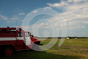 Fire engine on the edge of flying field of helicopter airport