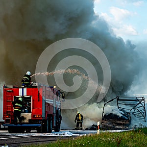 fire engine extinguishes a fire on the road