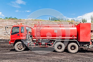 Fire engine or Fire truck in open-pit coal mine with blue sky background