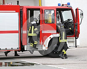 fire engine with many firefighters and equipment for fighting fire