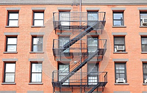 Fire escape ladders, brick building in New York. photo