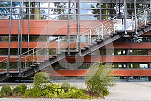 Fire escape staircase emergency exit on the background of the modern building facade