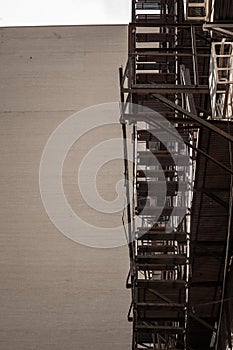 Fire escape stairs and ladder, in metal, on a typical North American old brick building from Montreal, Quebec, Canada