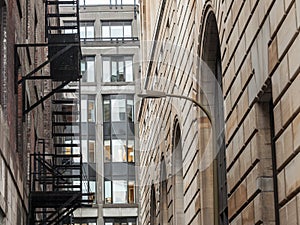 Fire escape stairs and ladder, in metal, on a typical North American old brick building from Montreal, Quebec, Canada.