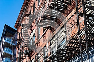 Fire Escapes on an Old Brick Building Next to a Modern Building in Long Island City Queens New York