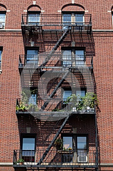 Fire Escapes with Potted Plants on an Old Brick Apartment Building in Astoria Queens New York