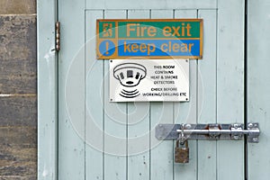 Fire exit keep clear sign on construction building site door