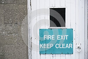 Fire exit keep clear sign rustic white door