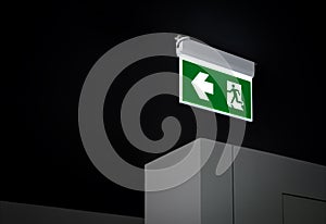 Fire exit sign. Green electric emergency evacuation escape sign with illuminated light.