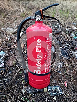 Fire extinguisher or dry chemical powder on burnt grass, first aid on fire, safety firem