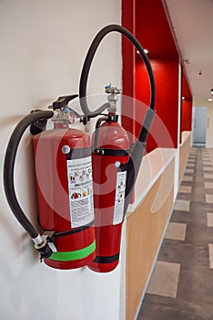 Fire extinguisher and gas pump system on the wall. Powerful emergency fire extinguisher equipment. Fire retardant. Fireproof.