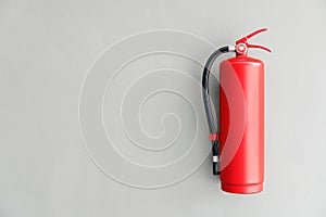Fire extinguisher on the gray wall. photo