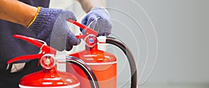 Fire extinguisher has hand engineer checking handle of fire extinguishers to prepare fire equipment for protection and prevent in
