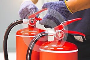 Fire extinguisher has hand engineer checking handle of fire extinguishers to prepare fire equipment for protection and prevent in