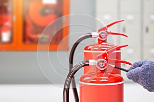 Fire extinguisher has hand engineer inspection checking pressure gauges to prepare fire equipment for protection