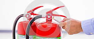 Fire extinguisher has hand engineer inspection checking pressure gauges to prepare fire equipment for protection