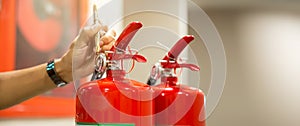 Fire extinguisher has hand engineer inspection checking pressure gauges to prepare fire equipment for protection