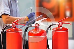 Fire extinguisher has hand engineer inspection checking pressure gauges to prepare fire equipment for protection and prevent in