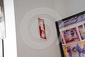 Fire extinguisher marker on white wall in restaurant area