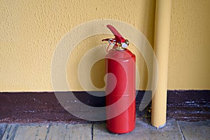 Fire extinguisher on the old floor