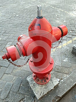 Fire extinguisher, old red hydrant by the roadside