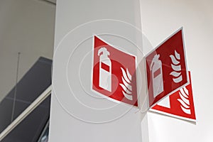 Fire extinguisher sign on the white wall.