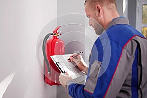 Fire Extinguisher Technician Ensuring Safety By Inspecting