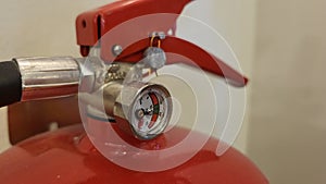 Fire extinguisher under preasure in daylight.