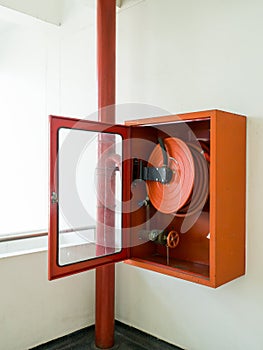 Fire extinguisher with various types of fire extinguishers Located In the white wall. copy space for text and content.