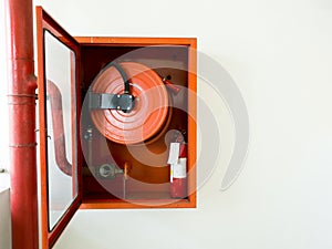 Fire extinguisher with various types of fire extinguishers Located In the white wall. copy space for text and content